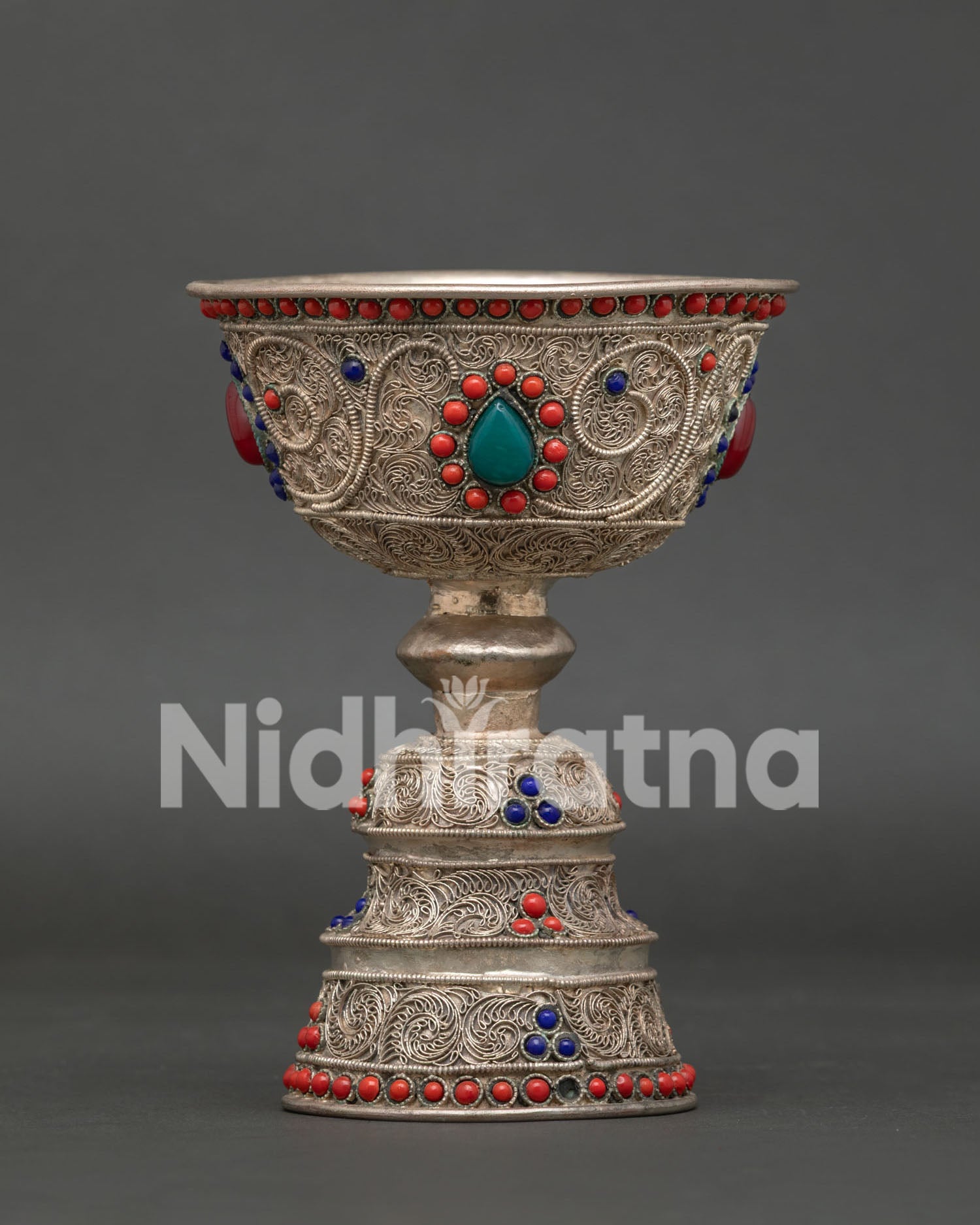 Nepalese butter lamp featuring intricate filigree artwork with turquoise coral and lapis lazuli
