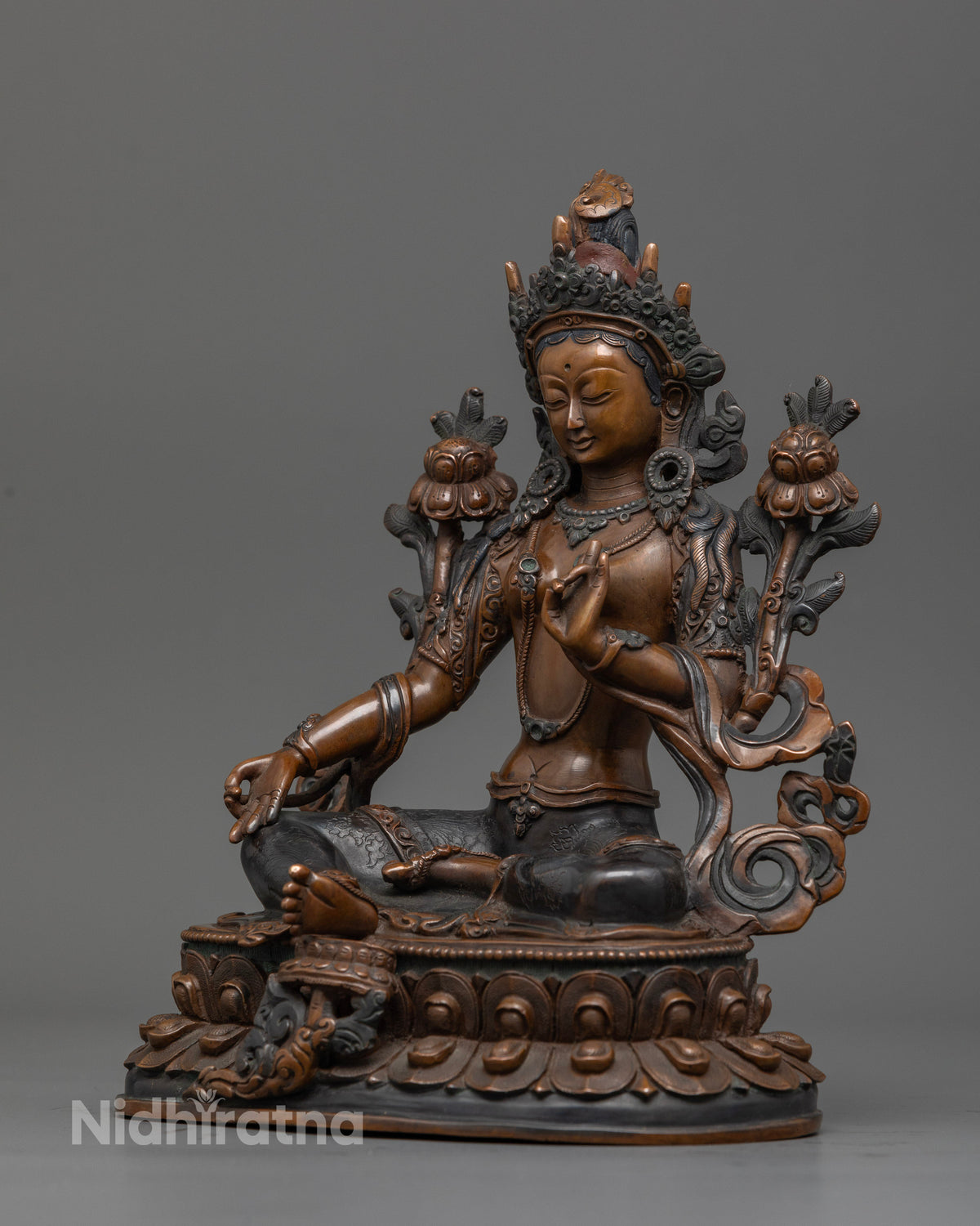 Nepalese Green Tara Buddhist statue with lotus stem representing purity and awakening