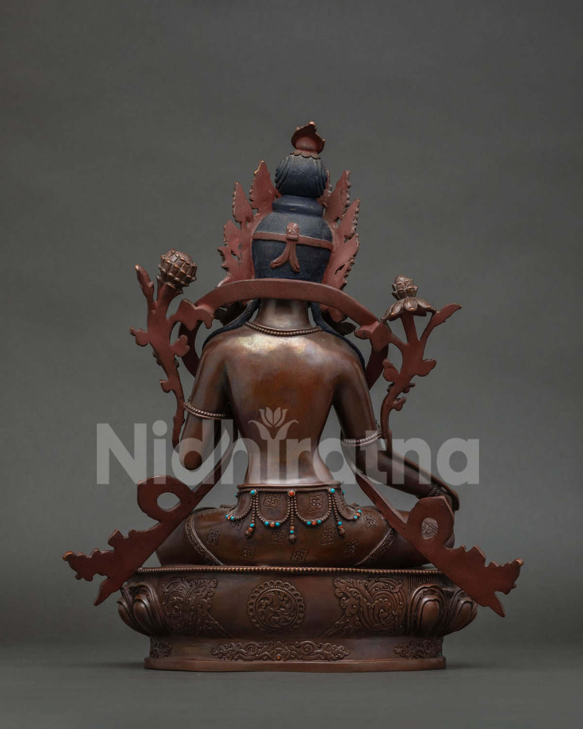 Nepalese Green Tara Statue seated on a handcarved lotus pedestal.