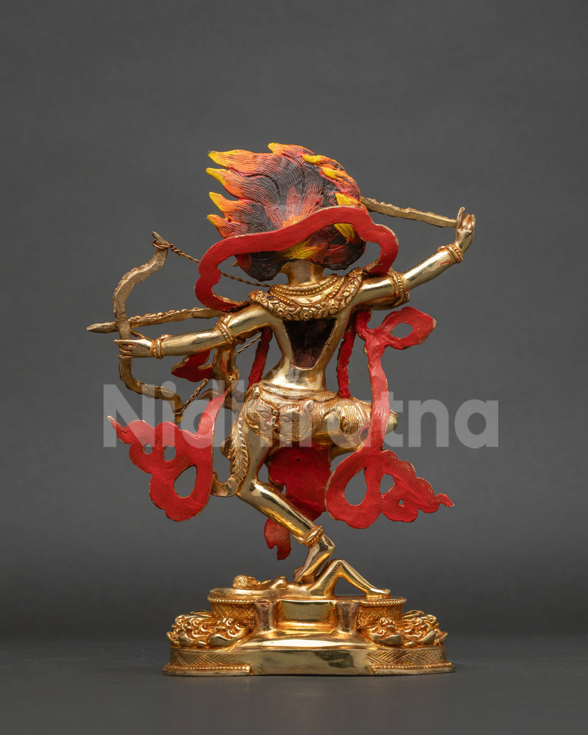 Nepalese kurukulla buddha statue with radiant gold finish and dramatic flame and skull halo.