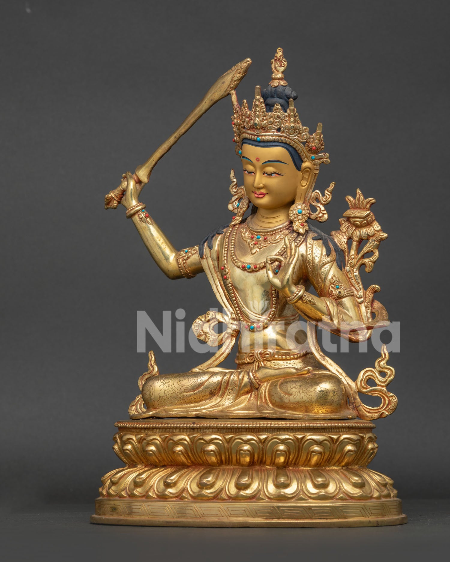 Nepalese Manjushri Statue with utpala flower and Prajnaparamita scripture.