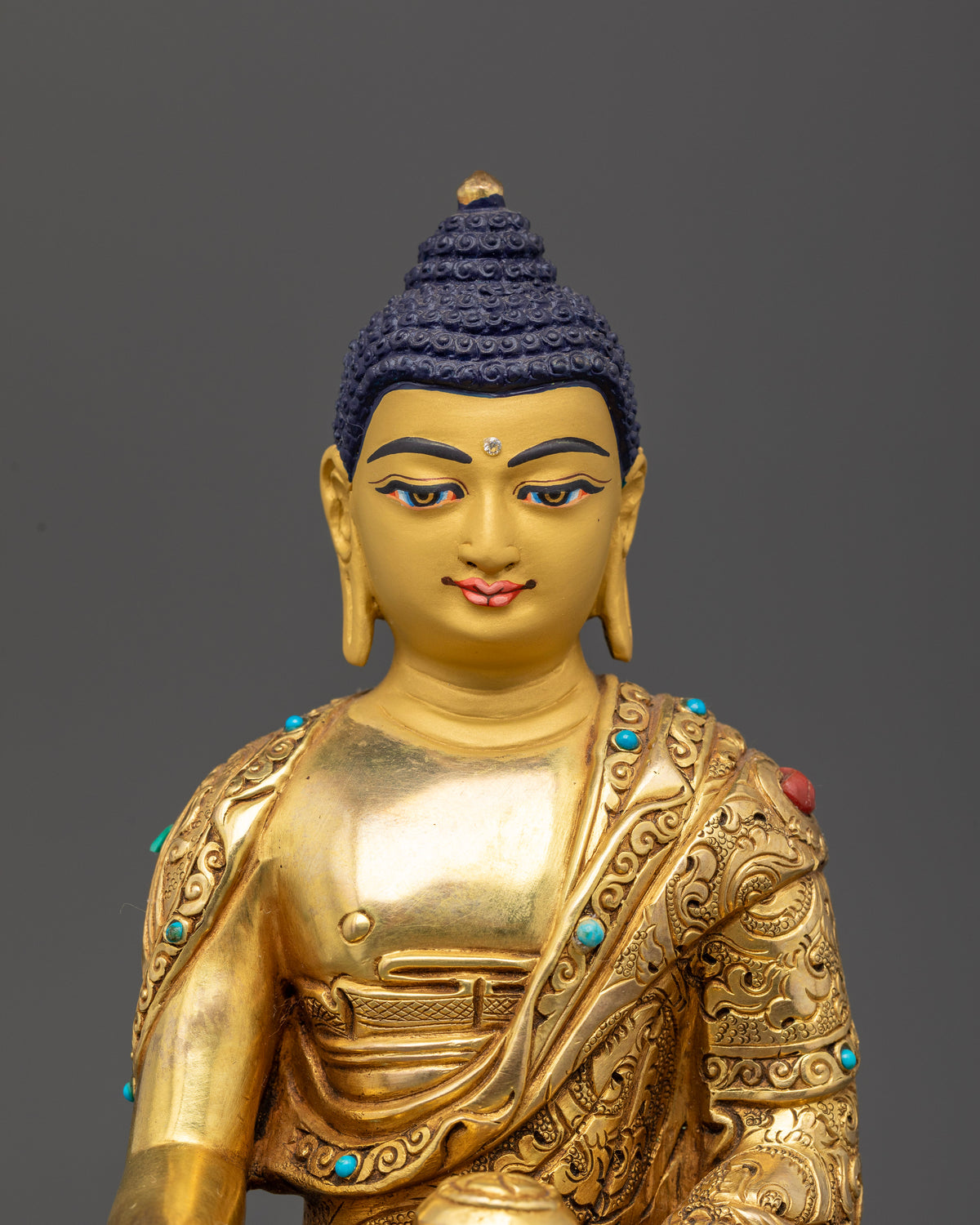 Nepalese Shakyamuni Buddha statue with a gold-painted face, jeweled monastic robe, and traditional lost-wax casting
