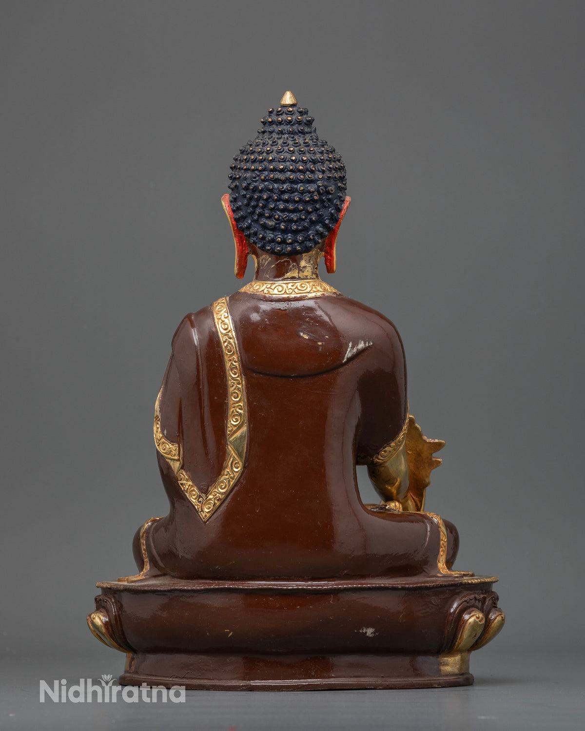 Newari handcrafted Medicine Buddha statue from Patan Nepal showcasing traditional metalworking artistry.