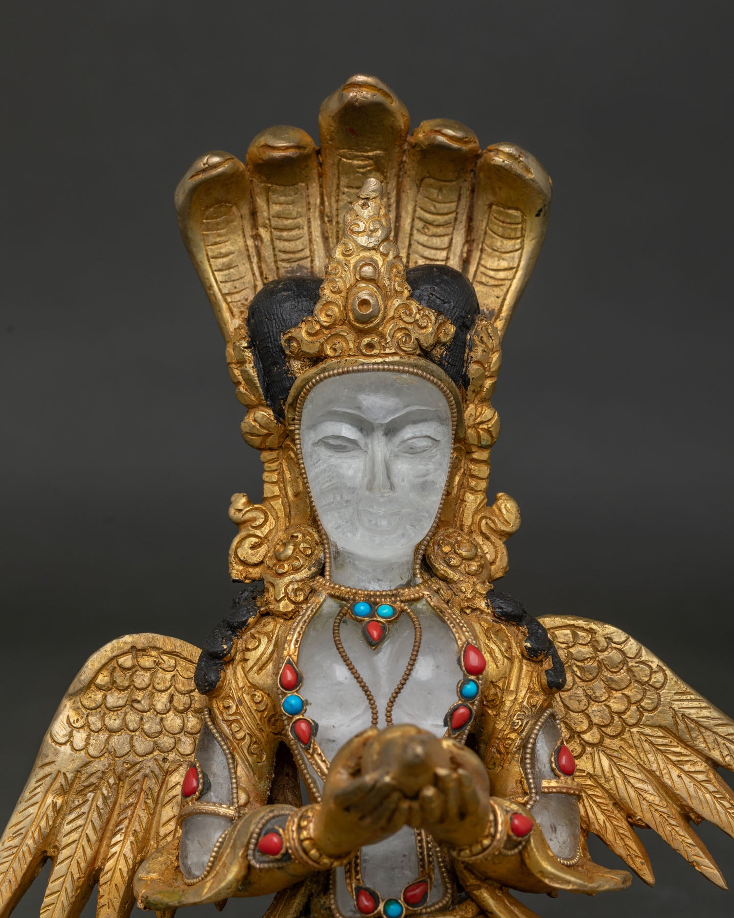 Newari Naga Kanya deity holding sacred conch shell with intricate gold craftsmanship