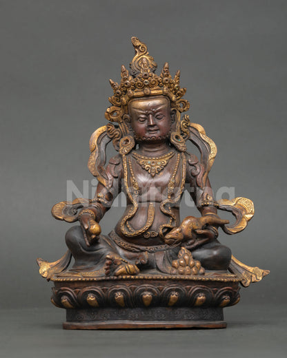 oxidized copper dzambhala statue seated on lotus pedestal with gold gilded details
