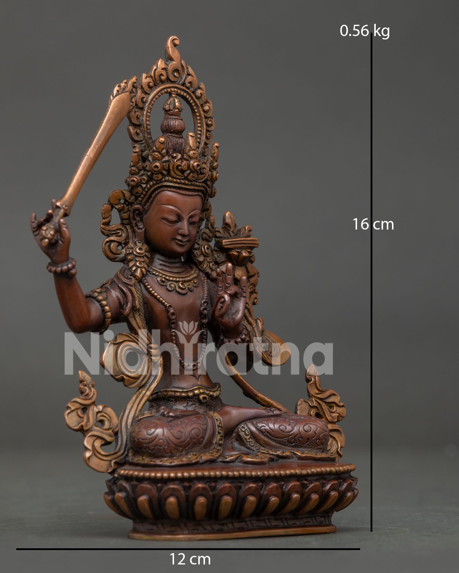 Oxidized copper Manjushri Statue seated on a lotus pedestal.