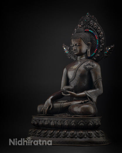 Left side view of oxidized copper Shakyamuni Buddha statue