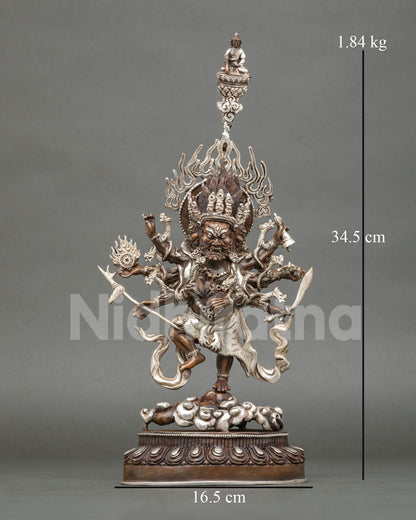 Oxidized copper Ucchusma statue with silver plating, front view of the wrathful deity with flaming halo