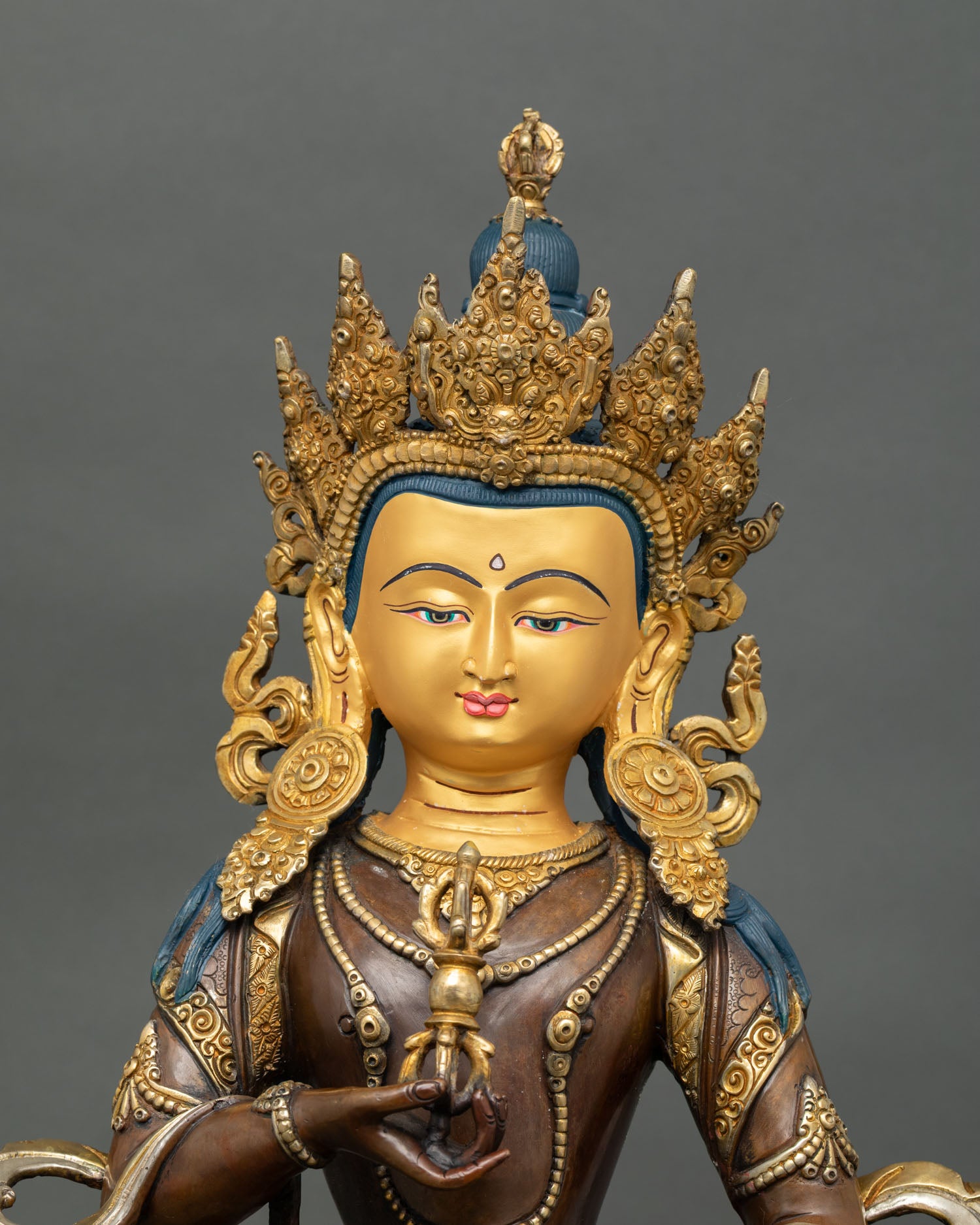 Oxidized Vajrasattva statue close up view handcrafted copper detailing and gold face Nepal