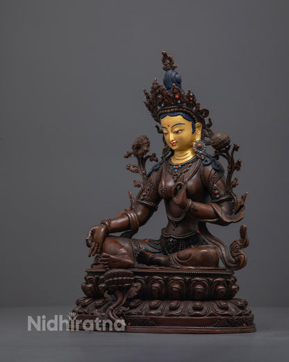 oxidized copper Green Tara Statue highlighting hand-painted acrylic colors and vivid Uptala flowers held gracefully in her left hand.