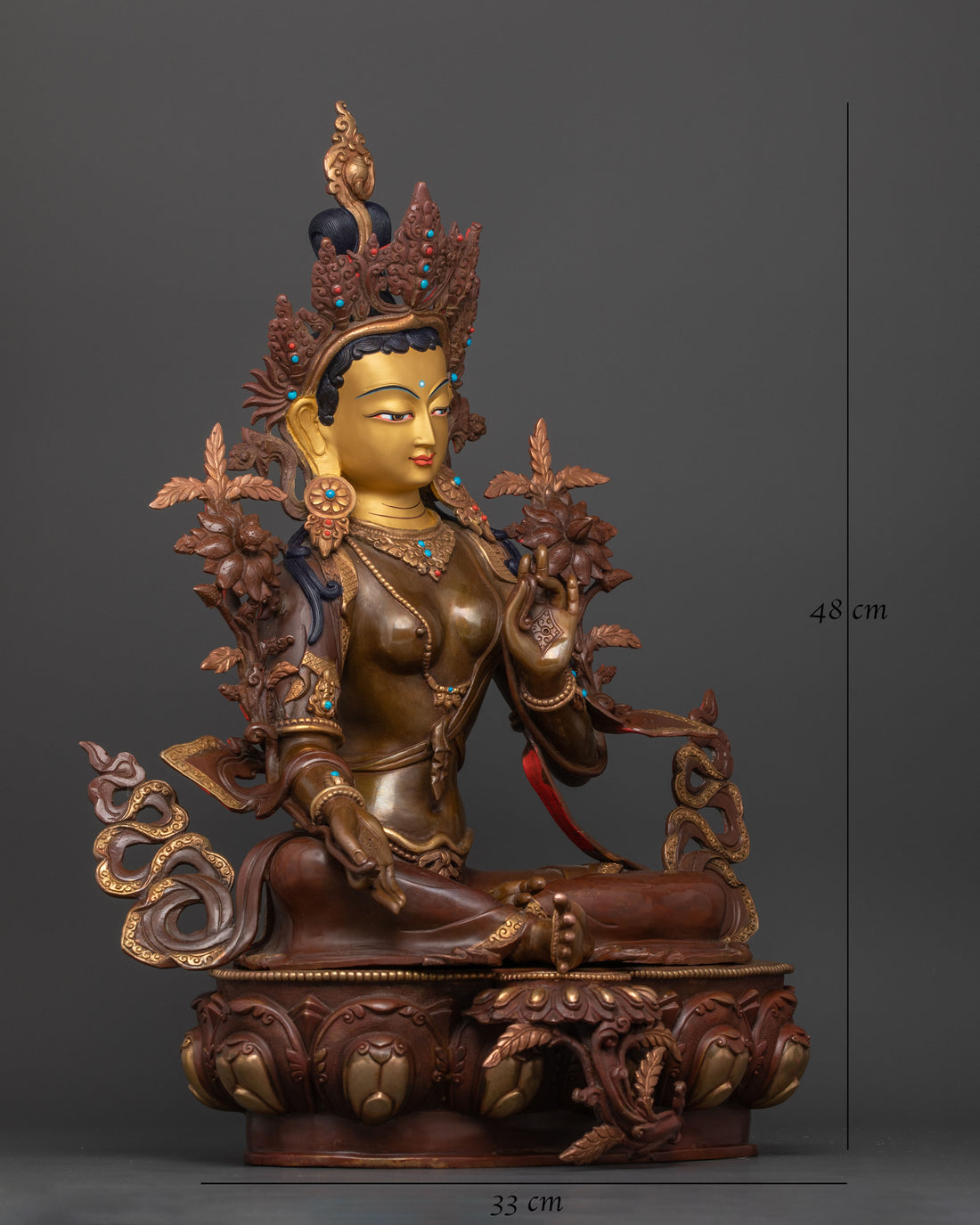 side profile of green tara statue with oxidized body and gold plated face