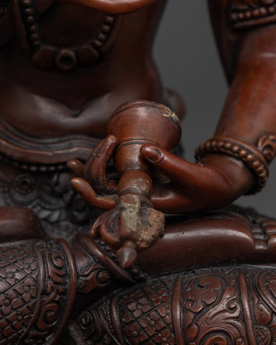 oxidized vajrasattva statue holding a bell in his hand