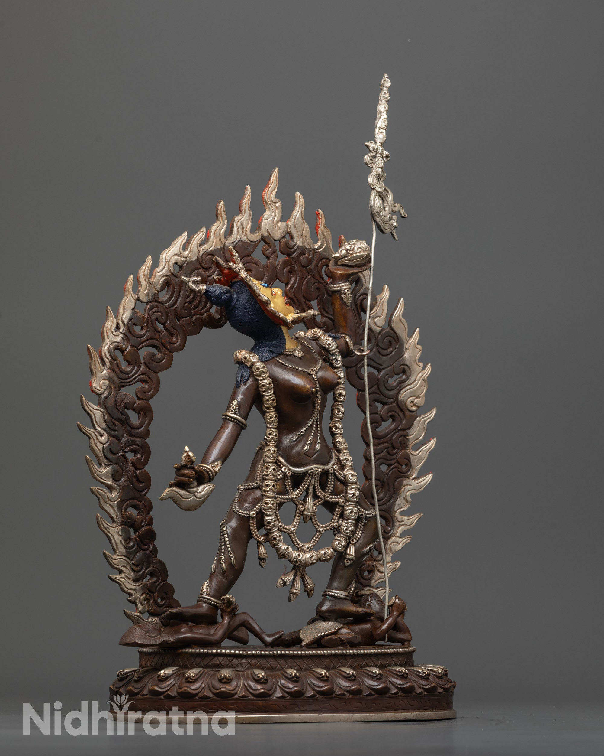 oxidized vajrayogini statue side view with khatvanga trident and skull crown details