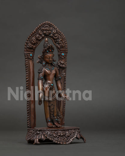 Padmapani statue with carved torana gateway Mara figures and Kirtimukha.
