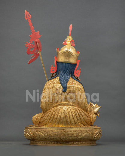 Padmasambhava statue back view, braided blue hair and cloud-scroll robe engraving, gold fire-gilded