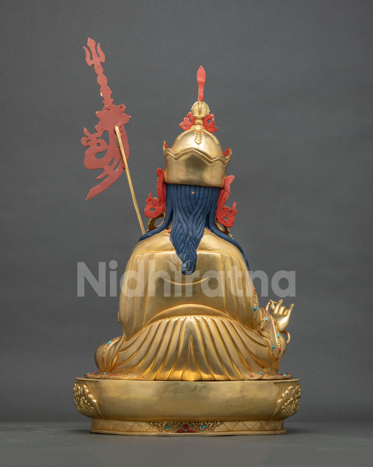 Padmasambhava statue back view, hand-painted blue hair and robe folds, gold fire-gilded copper