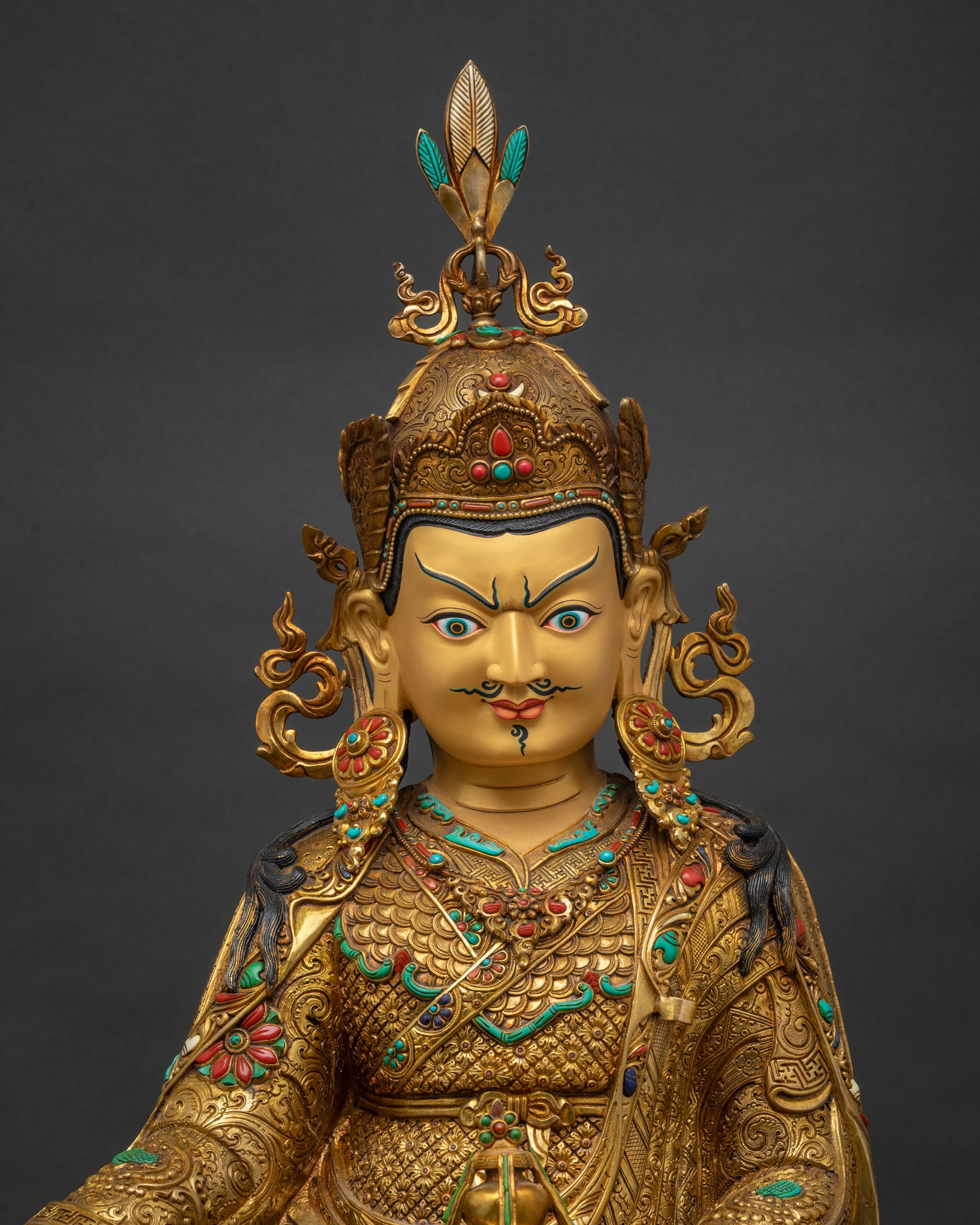 Padmasambhava statue close up, fire-gilded copper, khatvanga staff, lotus throne detail