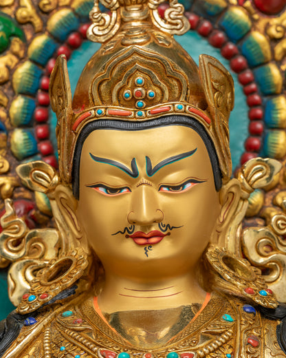 Padmasambhava statue face closeup with turquoise aureole halo backdrop