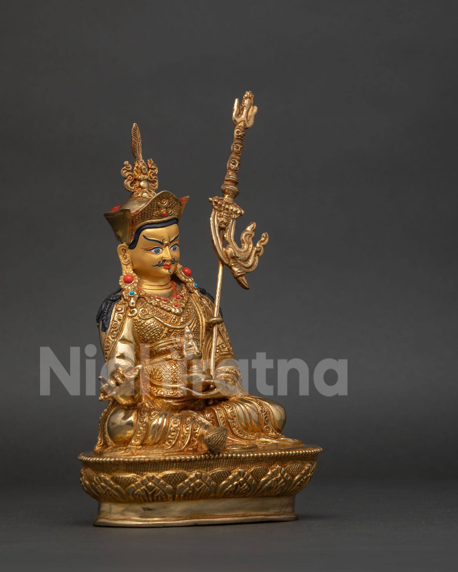 Padmasambhava statue red lotus hat vulture feather vajra skull cup.