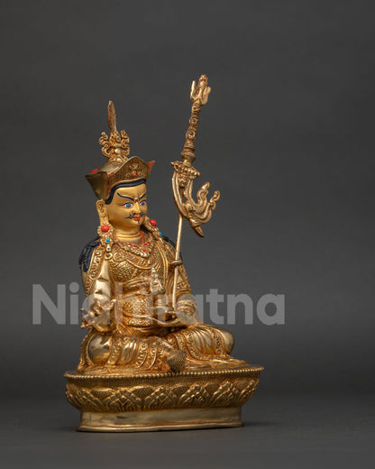 Padmasambhava statue red lotus hat vulture feather vajra skull cup.