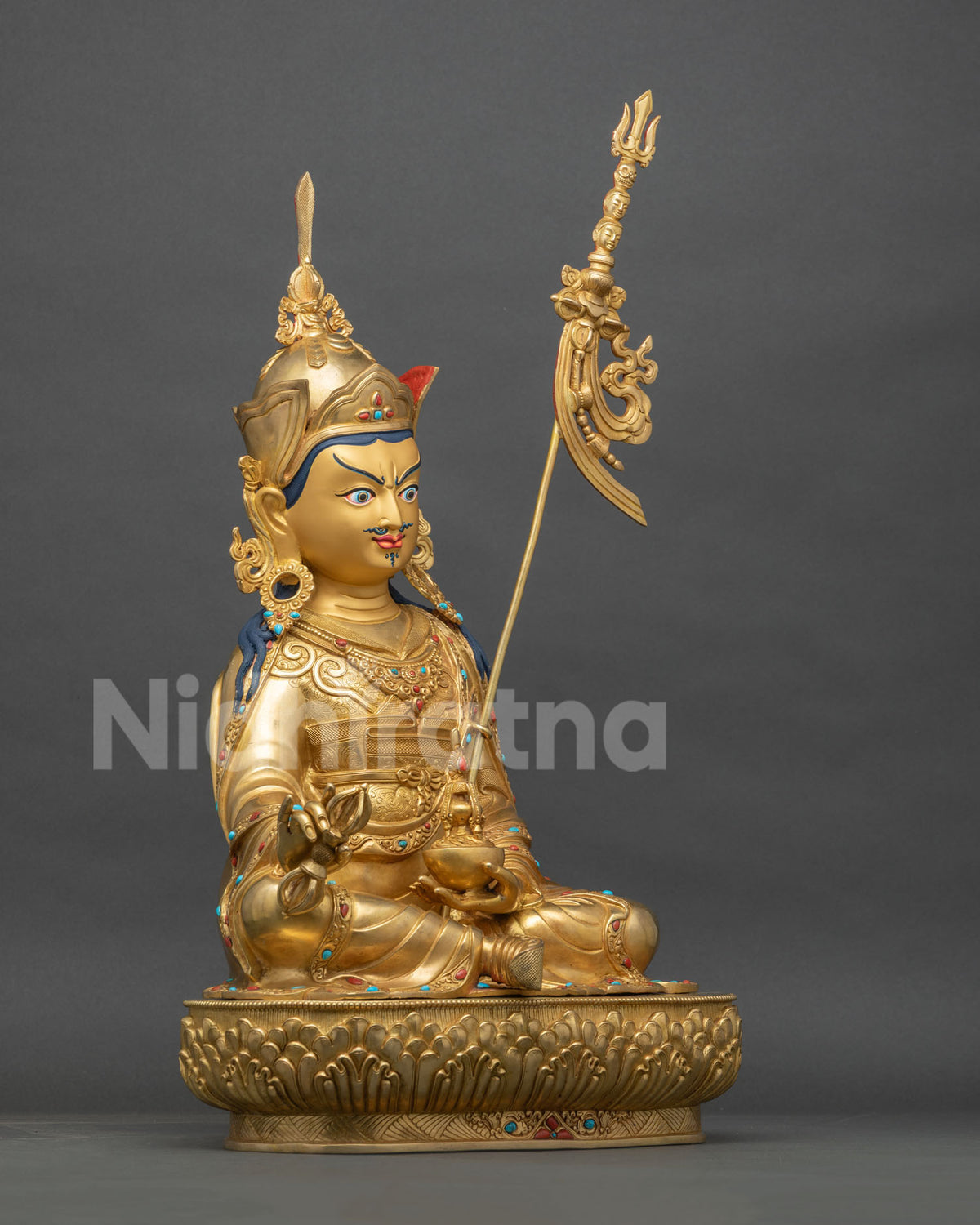 Padmasambhava statue right side view, gold fire-gilded copper Guru Rinpoche on a tiered lotus pedestal