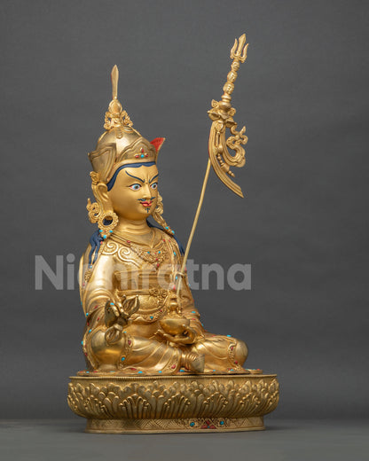 Padmasambhava statue right side view, gold fire-gilded copper Guru Rinpoche on a tiered lotus pedestal