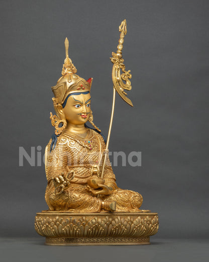 Padmasambhava statue right side view, vajra, skull cup and khatvanga in gold fire-gilded copper