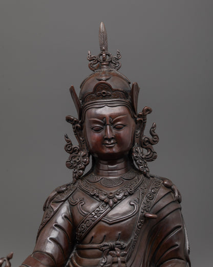 padmasambhava statue close up showing oxidized copper face and detailed artisan carvings
