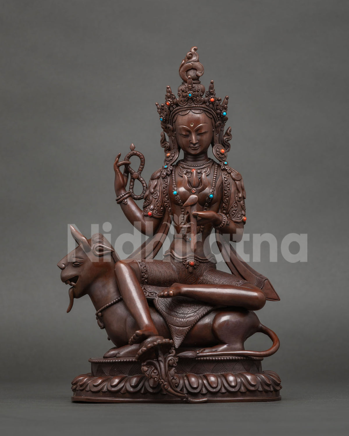 Paripurani Tara statue with trident on a mythical mount, fulfiller of aims, oxidized copper