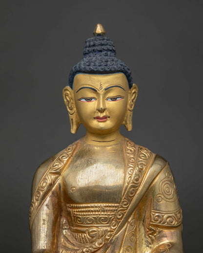 Ratnasambhava Buddha statue close up 24k gold painted face.