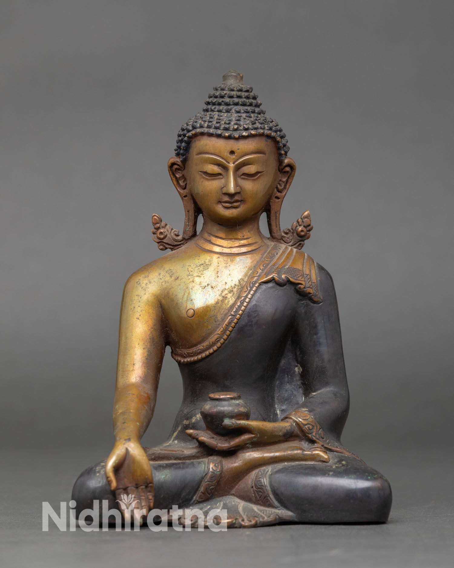 Ratnasambhava Buddha statue Varada mudra gesture of generosity and abundance oxidized copper Himalayan Five Wisdom Buddhas sacred sculpture