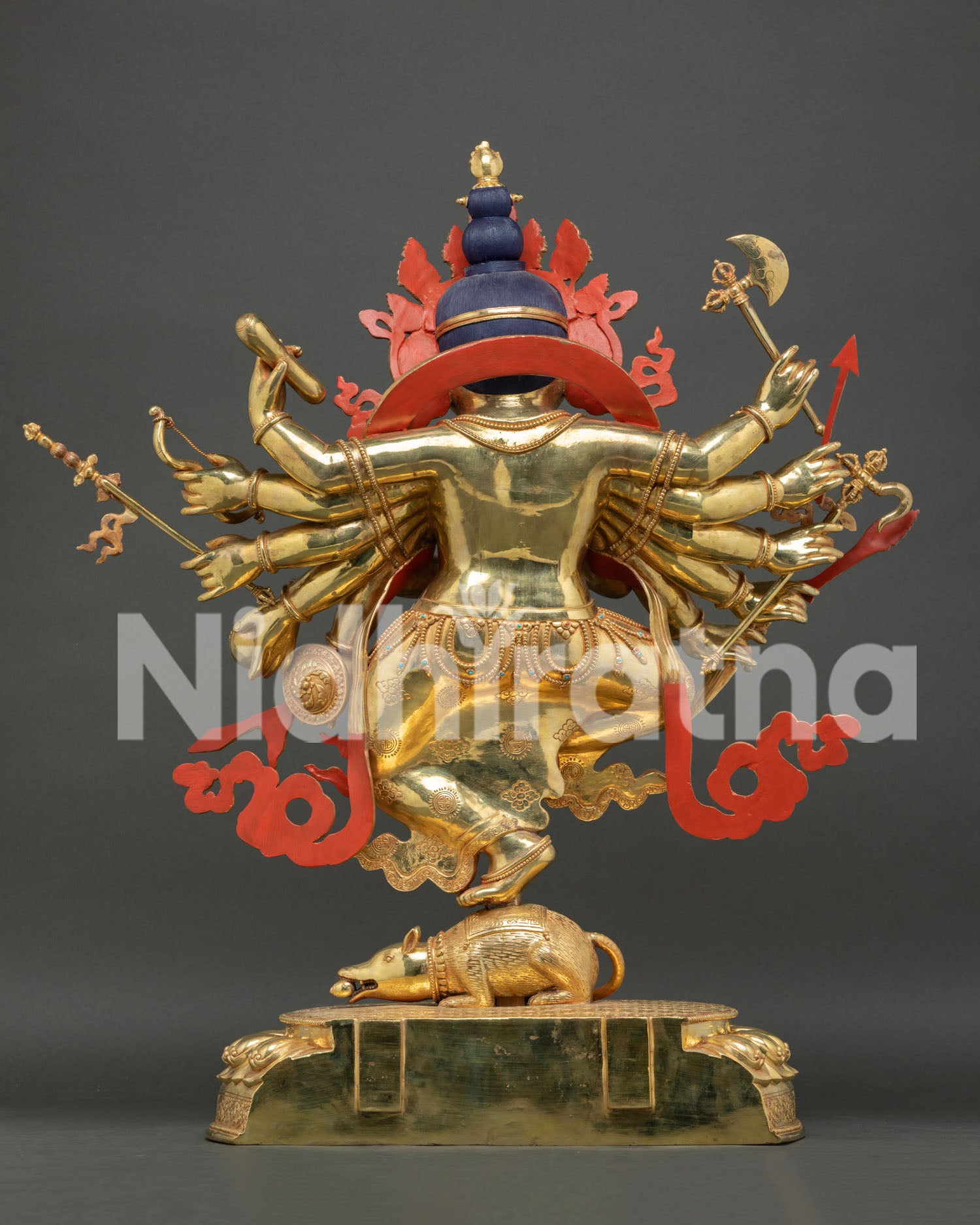 Rear view gold Ganesh statue with unpainted red aureole backdrop