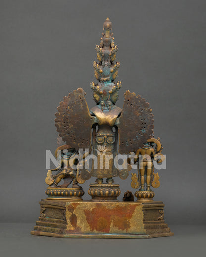 Rear view of 1000-Arm Chenrezig statue displaying halo back and pedestal base