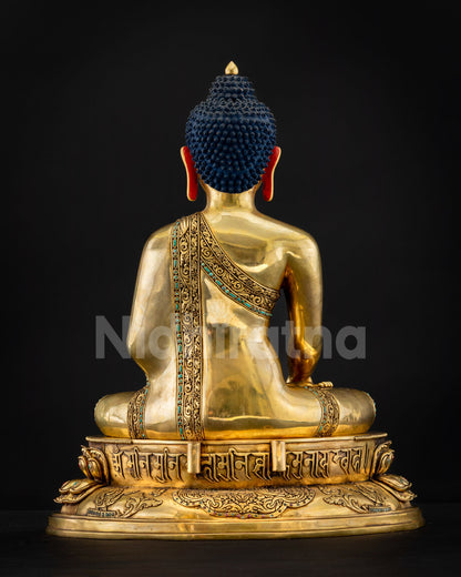 Rear view of Amitabha Buddha statue, blue Ushnisha, patterned robe, Tibetan mantra at base