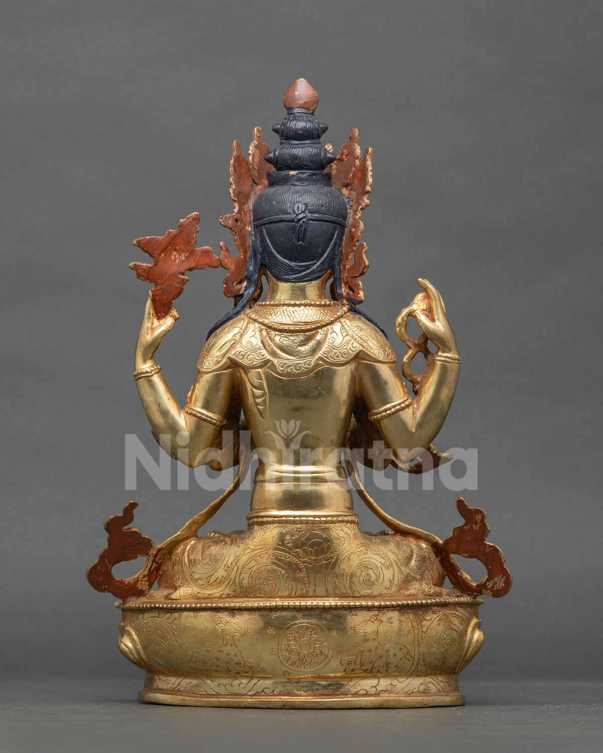 Rear view of Chenrezig statue showing red flame halo