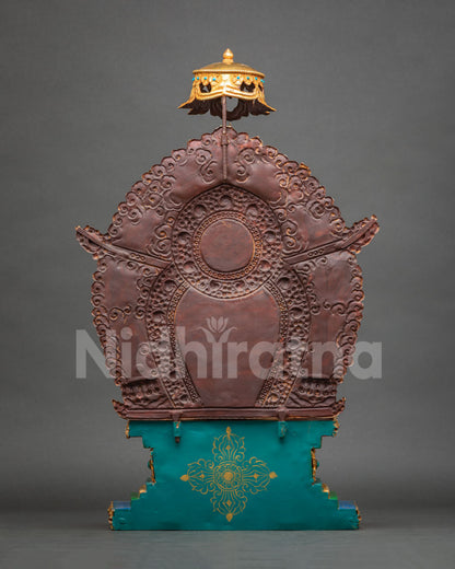 Rear view of copper halo backplate with embossed scroll motifs and parasol finial on Buddha statue