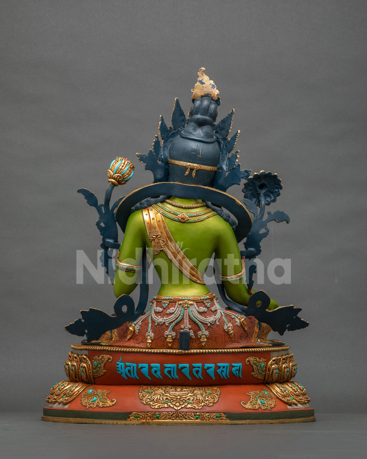 Rear view of handcrafted Green Tara statue showing turquoise mantra inscription on the copper base