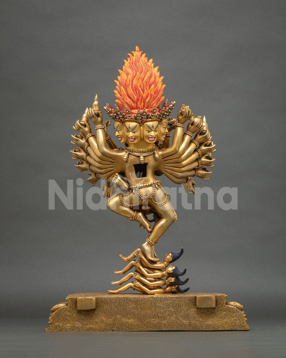 Rear view of Hevajra statue without halo, showing flaming crown, fanned arms and Maras underfoot