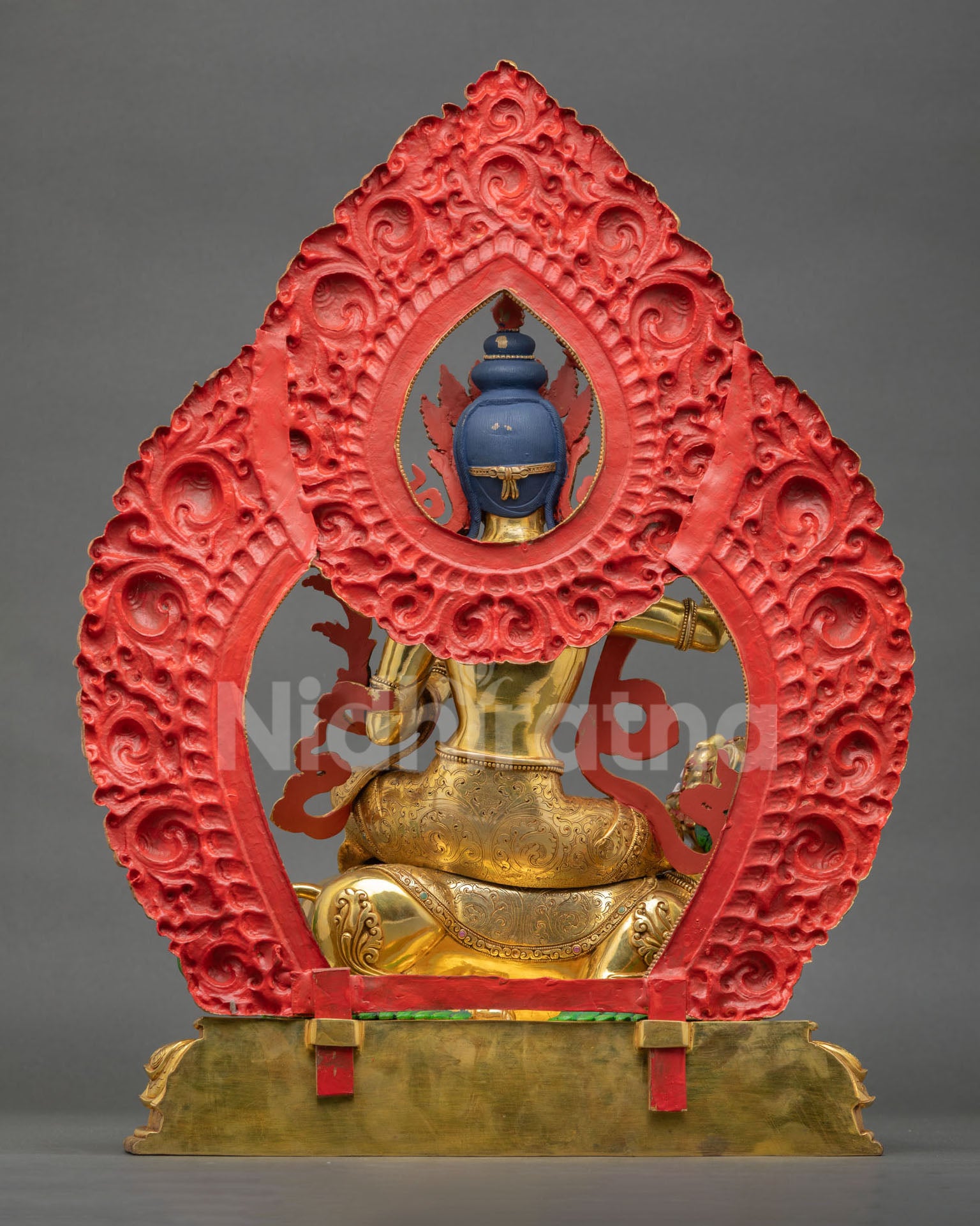 rear view of manjushri statue, detailed halo back design and copper gold gilded finish