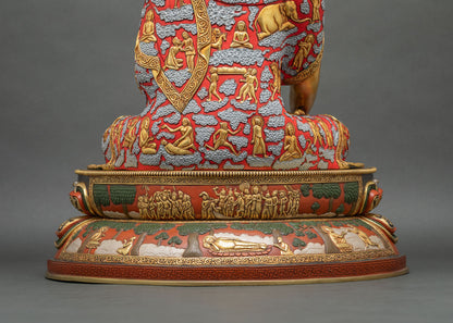 Rear view of Shakyamuni Buddha statue base carved with life scenes, trees, and the reclining Buddha