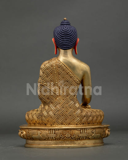 Rear view of Shakyamuni Buddha statue showing detailed craftsmanship, robe engravings and lotus base