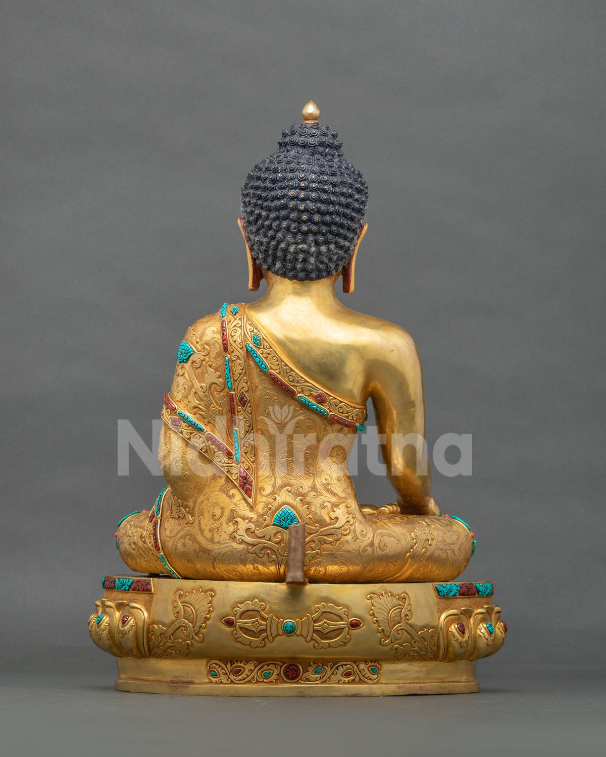Rear view of Shakyamuni Buddha statue with hand-incised robe and vajra on lotus base