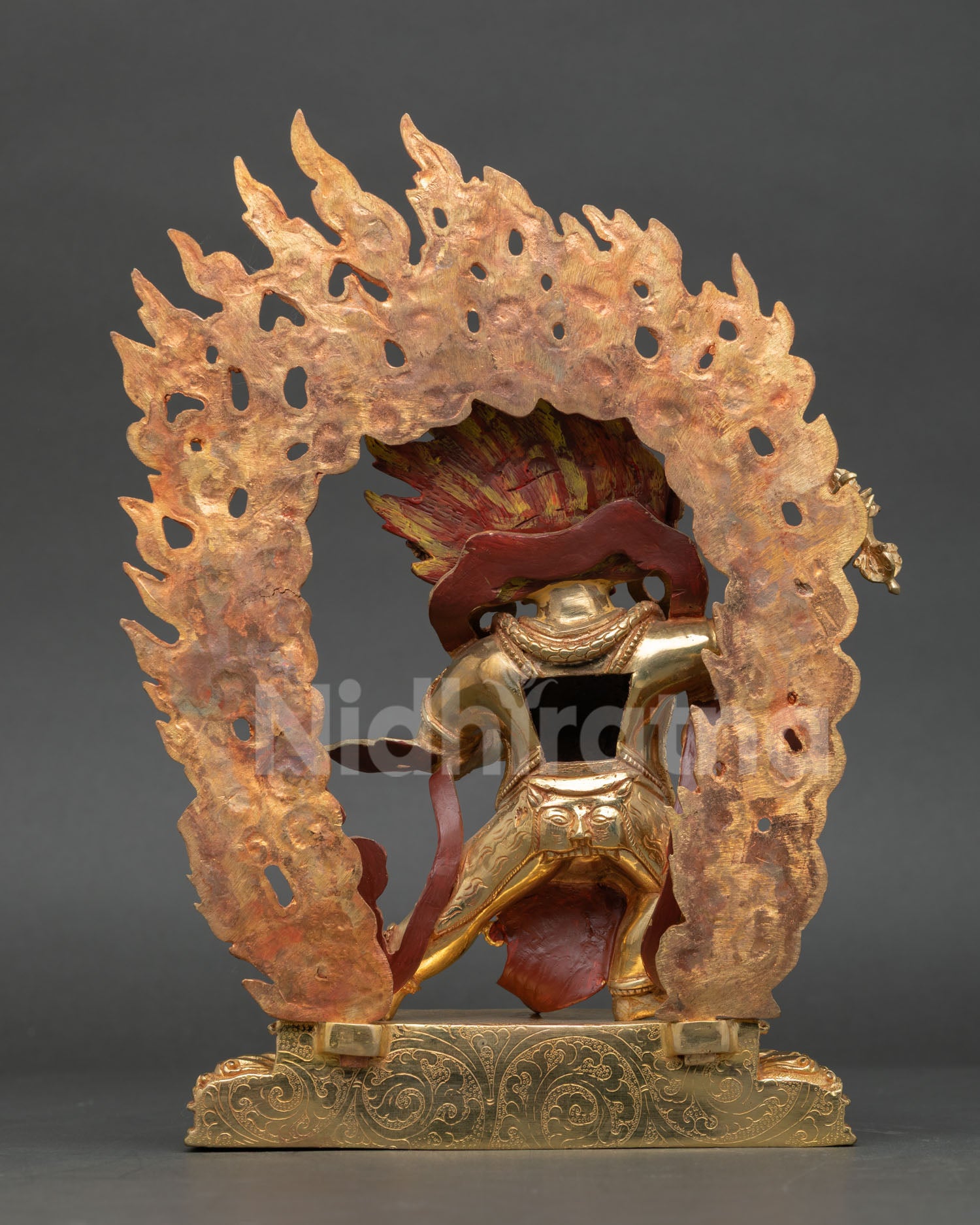 rear view of vajrapani statue displaying detailed craftsmanship and gilded finish