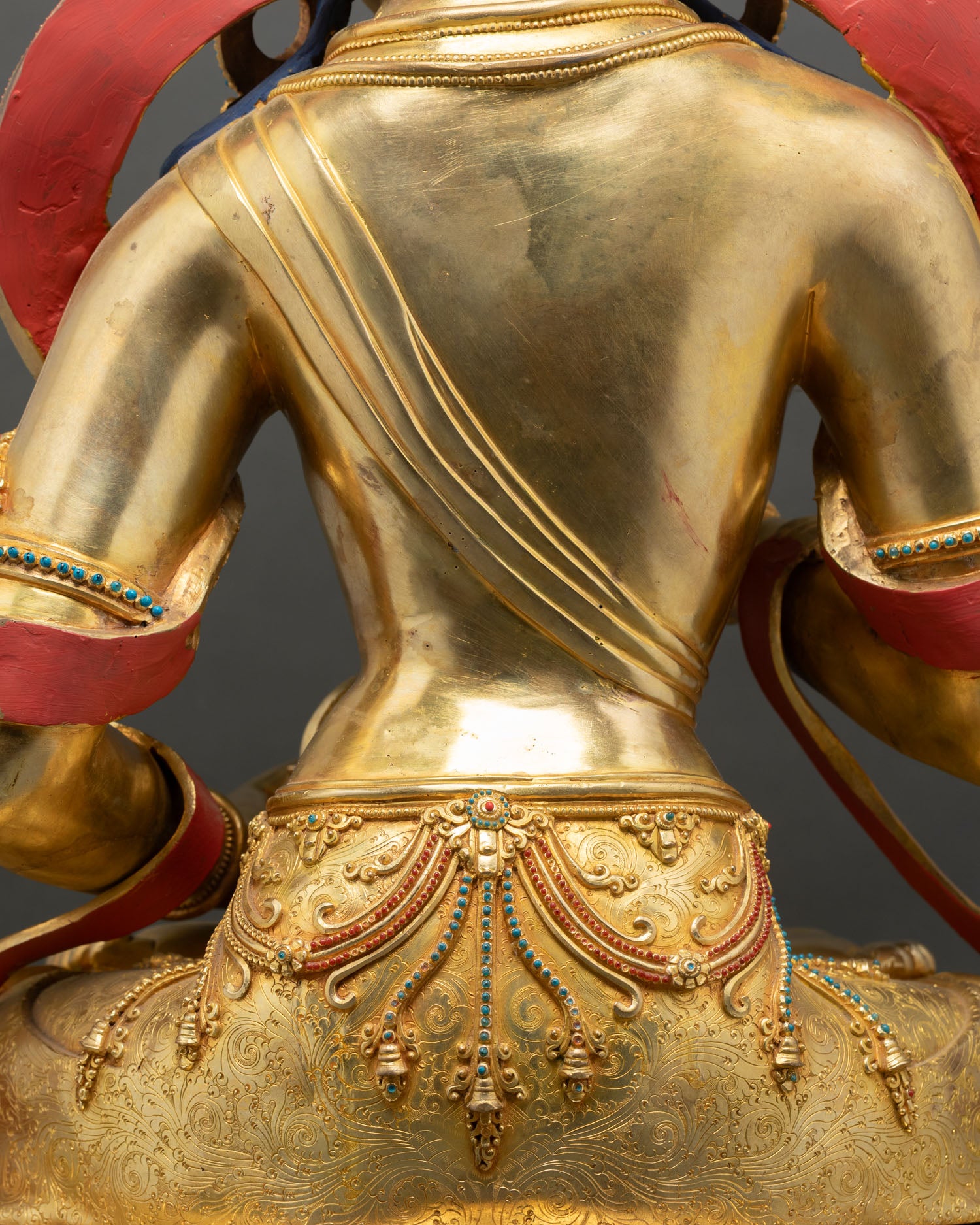 Rear view Vajrasattva statue back details golden robe draped repoussé copper Nepal