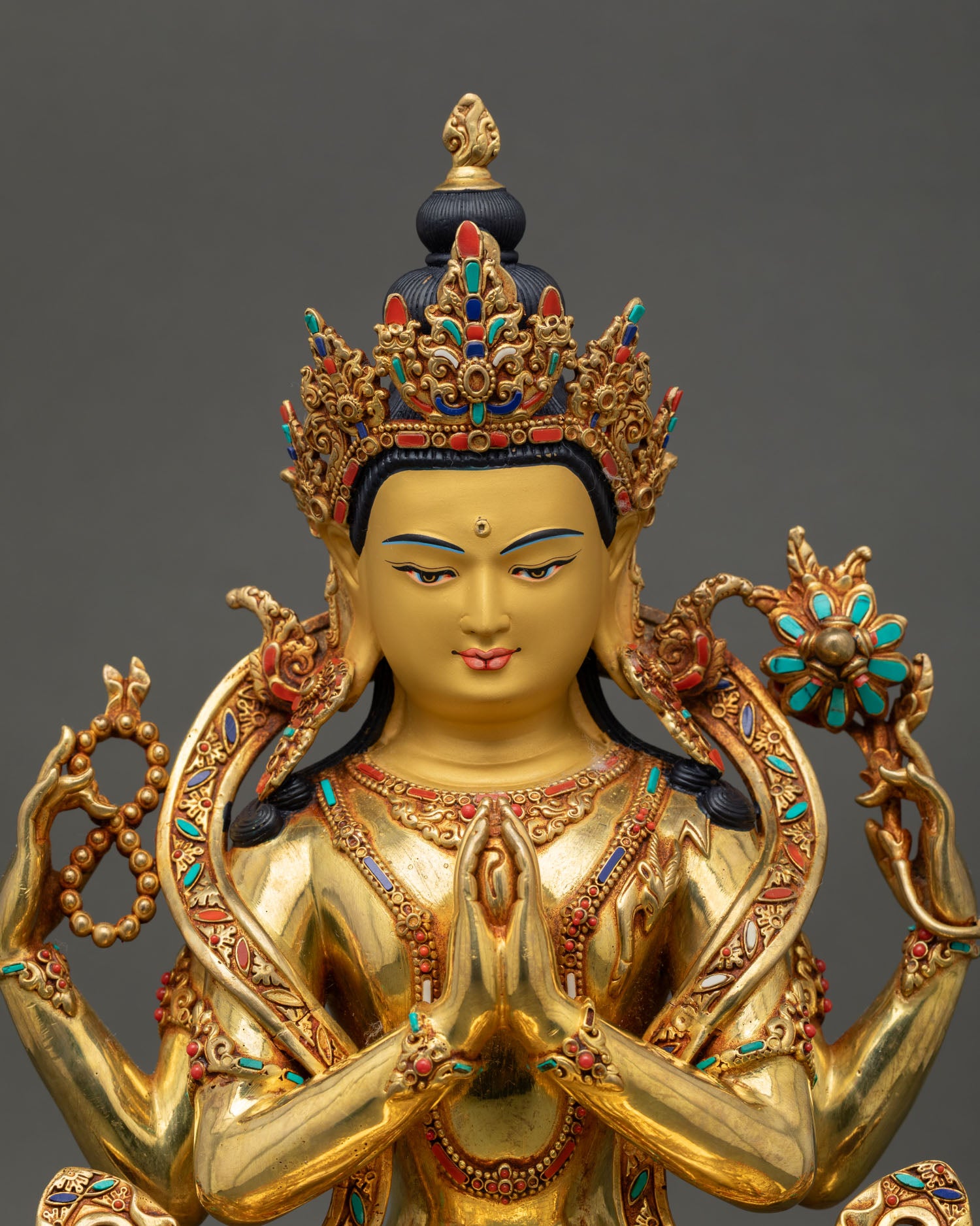 Regular close up Chenrezig statue showing intricate copper and gold details