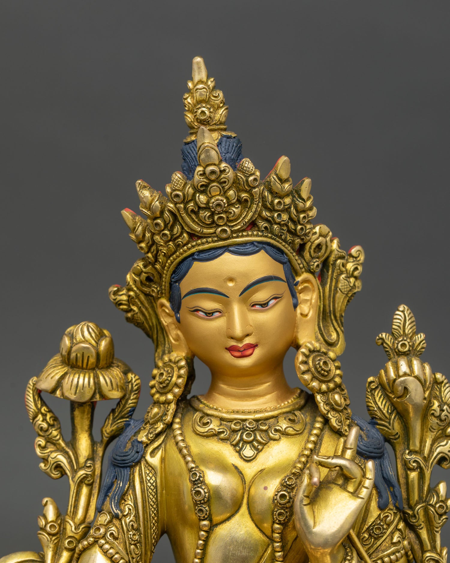 detailed green tara bodhisattva statue showing copper and gold craftsmanship