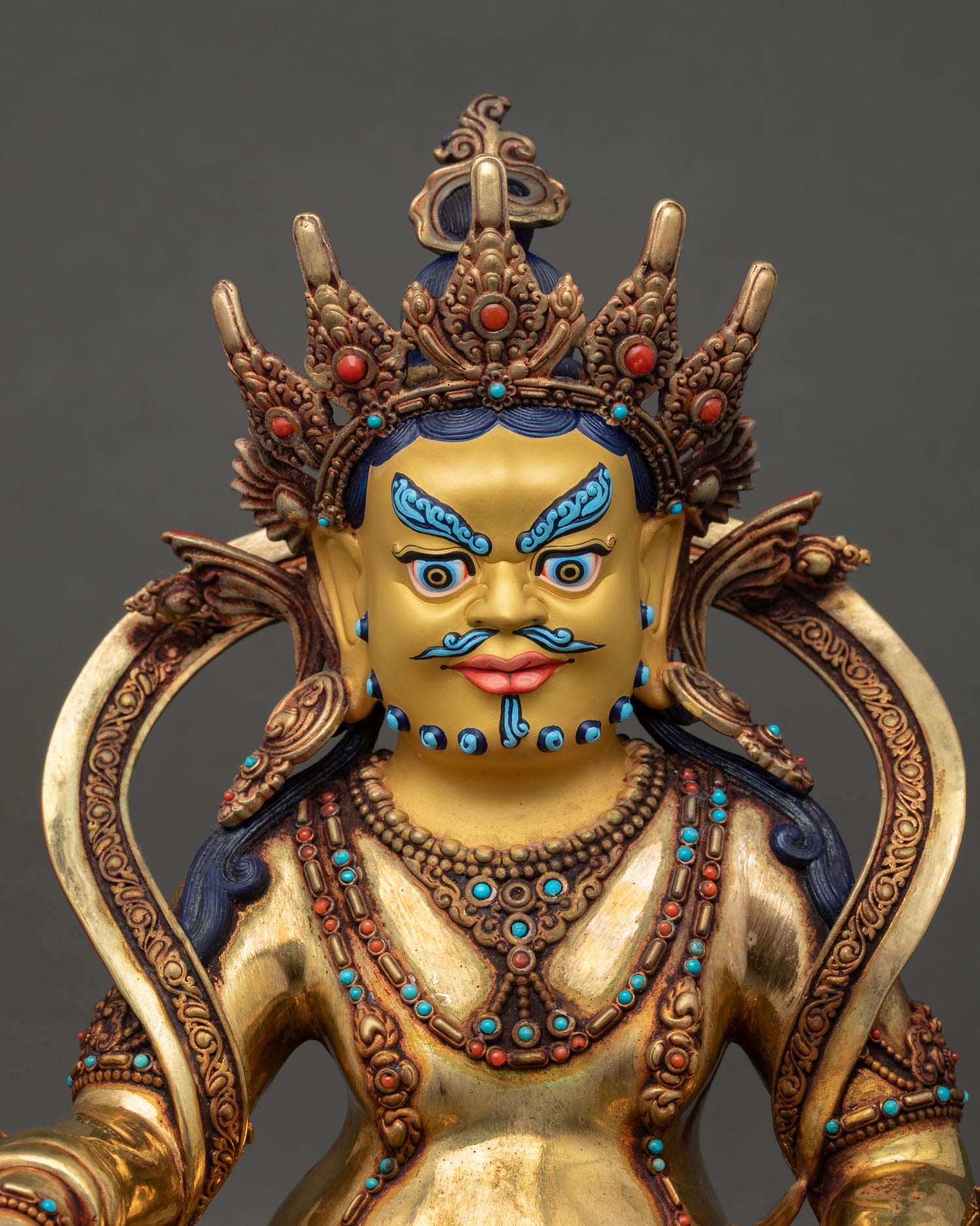 regular close up dzambhala figurine showing intricate carvings and prosperity symbols