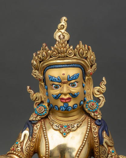 Regular close-up of Dzambhala statue, detailed copper and gold craftsmanship