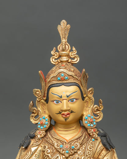 Regular close-up of Guru Rinpoche statue showing intricate gold and copper details