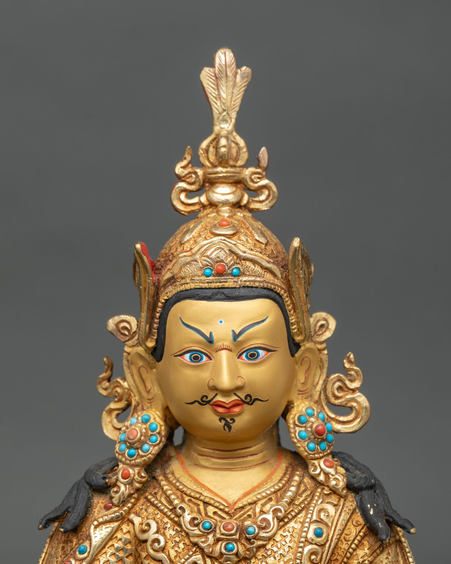 Regular close-up of Guru Rinpoche trio statue showing intricate gold and gemstone details